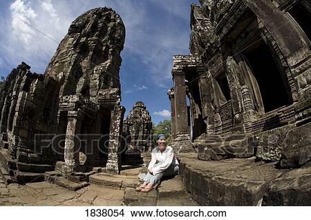 Picture - Tourist Outside Bayon Temple In Ancient City Of Angkor; Angkor Wat, Siem Reap, Cambodia. Fotosearch