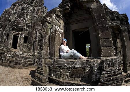 Stock Image - Tourist Outside Bayon Temple In Ancient City Of Angkor; Angkor Wat, Siem Reap, Cambodia. Fotosearch