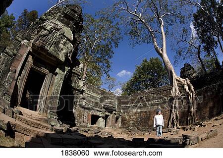 Stock Image - Tourist Outside Temple In Ancient City Of Angkor; Angkor Wat, Siem Reap, Cambodia. Fotosearch