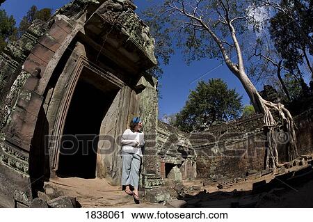 Stock Image - Tourist Outside Temple In Ancient City Of Angkor; Angkor Wat, Siem Reap, Cambodia. Fotosearch