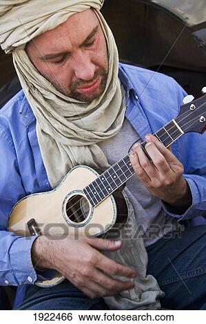 Tourist Playing Ukulele View Large Photo Image Stock Photograph - Tourist Playing Ukulele. Fotosearch