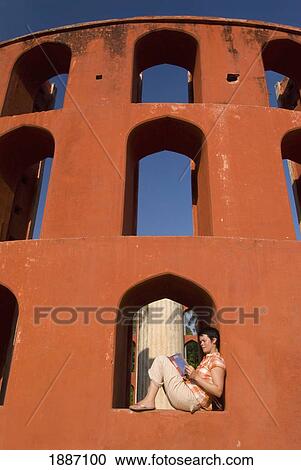 Stock Image - Tourist Reading Guide Book In The Jantar Mantar Observatory. Fotosearch