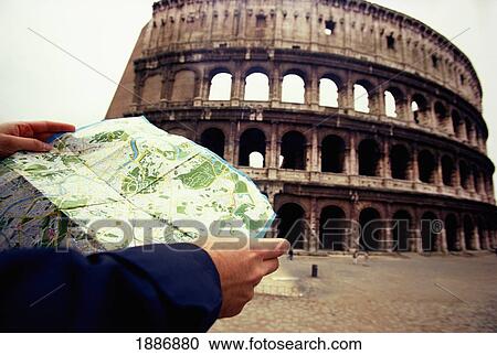 Stock Image - Tourist Reading Map Outside Coliseum. Fotosearch