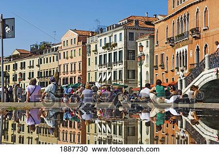 Stock Image - Tourist Resting By Fountain In Venice.. Fotosearch