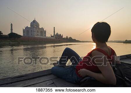 Stock Photography - Tourist Sitting On Deck Of Boat Admiring The Taj Mahal. Fotosearch