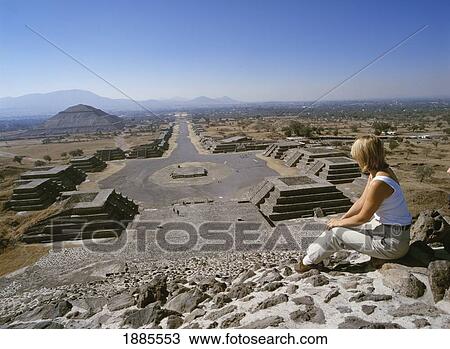 Stock Image - Tourist Sitting On Top Of Pyramid. Fotosearch