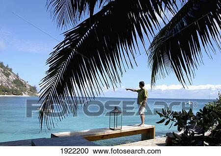 Stock Image - Tourist Spotting Stringrays. Fotosearch