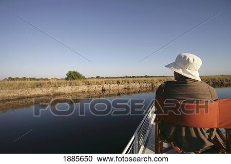 Stock Image - Tourist Taking A Boat Trip On Kwando River. Fotosearch