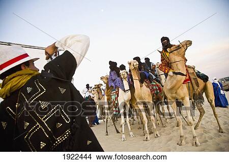 Tourist Taking Photos Of Tuaregs On Camels View Large Photo Image Picture - Tourist Taking Photos Of Tuaregs On Camels. Fotosearch