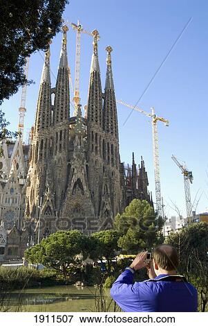Stock Photo - Tourist Taking Pictures Of Sagrada Familia, Barcelona, Spain. Fotosearch