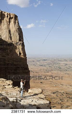 Tourist trekking in the amazing mountain scenery on the Gheralta plateau; Tigray region, Ethiopia View Large Photo Image Stock Image - Tourist trekking in the amazing mountain scenery on the Gheralta plateau; Tigray region, Ethiopia. Fotosearch