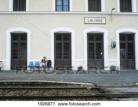Stock Image - Tourist Waiting For Train At Lalinde Station. Fotosearch