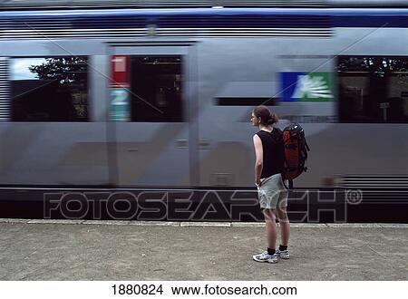 Picture - Tourist Waiting To Board Train At Lalinde Station. Fotosearch