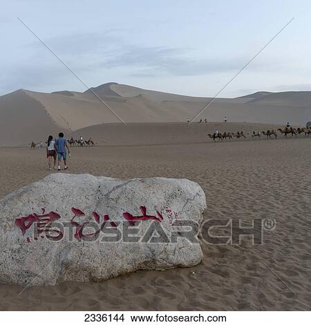 Picture - Tourists And Camel Riding At Mingsha Mountain; Jiuquan, Gansu, China. Fotosearch