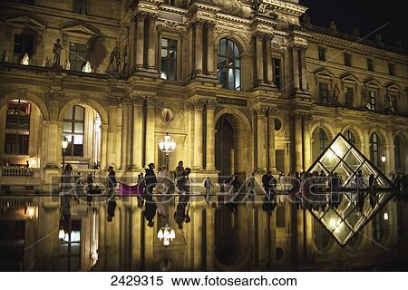 Tourists are reflected in the pools out the front of The Louvre Museum; Paris, France View Large Photo Image Stock Photography - Tourists are reflected in the pools out the front of The Louvre Museum; Paris, France. Fotosearch