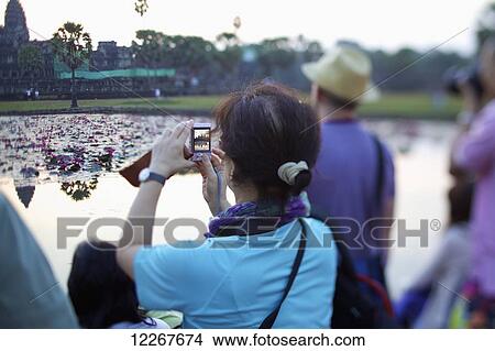 Tourists at Angkor Wat; Siem Reap, Cambodia View Large Photo Image Picture - Tourists at Angkor Wat; Siem Reap, Cambodia. Fotosearch