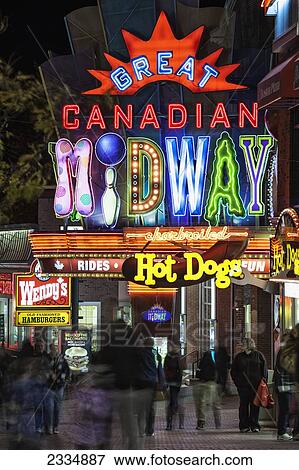 Stock Photo - Tourists At Great Canadian Midway At Night; Niagara Falls Ontario Canada. Fotosearch
