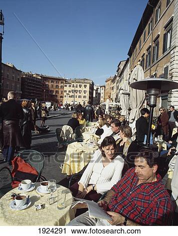 Stock Image - Tourists At Piazza Navona Cafe. Fotosearch