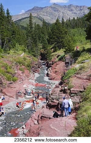 Tourists At Red Rock Canyon In Waterton Lakes National Park; Alberta, Canada View Large Photo Image Stock Image - Tourists At Red Rock Canyon In Waterton Lakes National Park; Alberta, Canada. Fotosearch