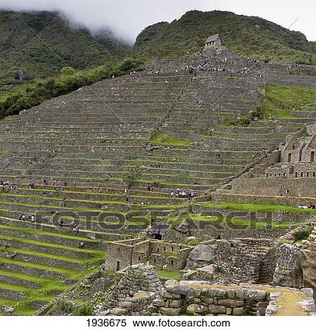 Stock Photography - Tourists At The Historic Inca Site Machu Picchu; Peru. Fotosearch