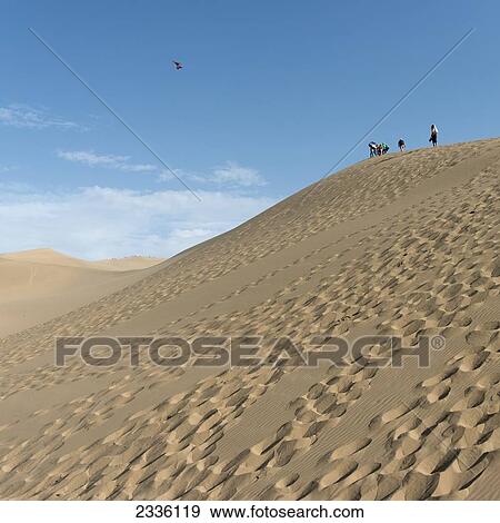 Tourists At The Top Of Singing Sand Mountain; Jiuquan, Gansu, China View Large Photo Image Stock Photo - Tourists At The Top Of Singing Sand Mountain; Jiuquan, Gansu, China. Fotosearch