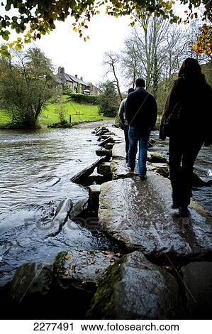 Tourists crossing the Tarr Steps, a prehistoric clapper bridge across the River Barle, Exmoor National Park; Somerset, England View Large Photo Image Stock Image - Tourists crossing the Tarr Steps, a prehistoric clapper bridge across the River Barle, Exmoor National Park; Somerset, England. Fotosearch