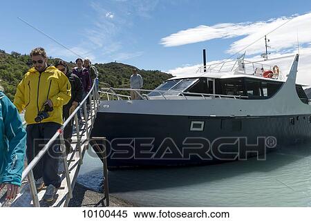 Stock Photography - Tourists disembarking from a tour boat, Los Glaciares National Park; Santa Cruz province, Argentina. Fotosearch