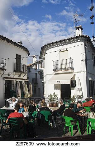 Stock Photo - Tourists eating and drinking in the town of Grazalema, the hub of the Sierra de Grazalema Natural Park, a Unesco Biosphere reserve since 1977. Andalucia, Spain. Fotosearch