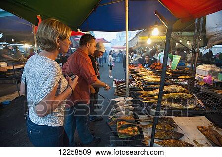 Tourists enjoying the night markets; Bandar Seri Begawan, Brunei View Large Photo Image Stock Photo - Tourists enjoying the night markets; Bandar Seri Begawan, Brunei. Fotosearch
