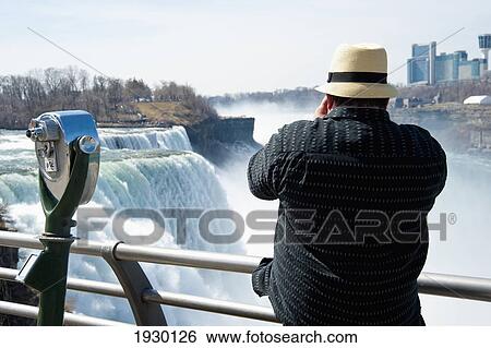 Stock Photograph - Tourists Enjoying The View Of Niagara Falls, Ontario And New York Border, Canada And United States Of America. Fotosearch