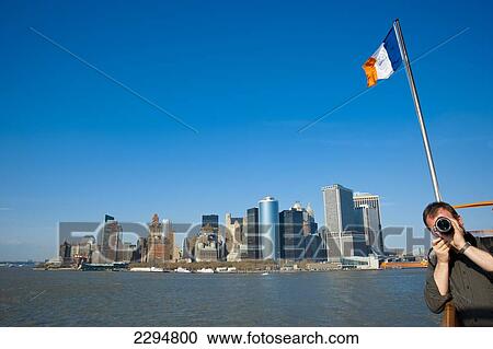 Tourists Enjoying The Views Of Manhattan From The Staten Island Ferry, New York, Usa View Large Photo Image Stock Image - Tourists Enjoying The Views Of Manhattan From The Staten Island Ferry, New York, Usa. Fotosearch