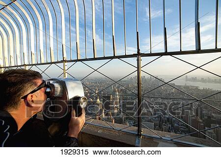 Tourists Enjoying The Views Of Manhattan From The Top Of The Empire State; New York, Usa View Large Photo Image Stock Photography - Tourists Enjoying The Views Of Manhattan From The Top Of The Empire State; New York, Usa. Fotosearch