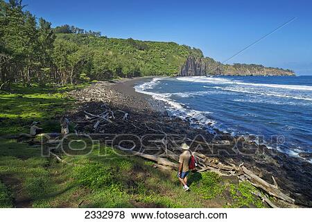 Stock Photo - Tourists explore the coastline and beach, Hawaii Pololu Valley; Big Island, Hawaii, United States of America. Fotosearch