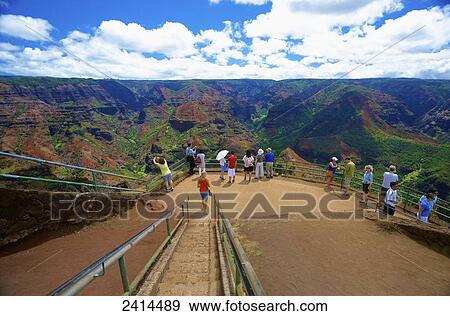 Tourists gather to view the mountainous landscape of Waimea Canyon State Park; Kauai, Hawaii, United States of America View Large Photo Image Stock Photo - Tourists gather to view the mountainous landscape of Waimea Canyon State Park; Kauai, Hawaii, United States of America. Fotosearch