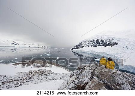 Tourists In Yellow Jackets By A Glacier; Antarctica View Large Photo Image Stock Photography - Tourists In Yellow Jackets By A Glacier; Antarctica. Fotosearch