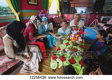 Stock Photo - Tourists inside a local house in the floating village; Bandar Seri Begawan, Brunei. Fotosearch