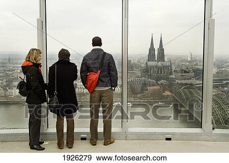 Tourists Looking At City Panorama Through Window, Cologne, Germany, Cologne Cathedral (Konler Dom) View Large Photo Image Stock Photo - Tourists Looking At City Panorama Through Window, Cologne, Germany, Cologne Cathedral (Konler Dom). Fotosearch
