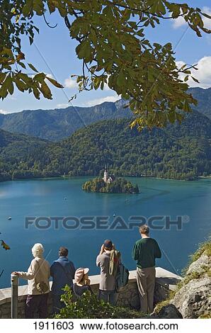 Stock Image - Tourists Looking At Lake Bled From Castle, Slovenia. Fotosearch