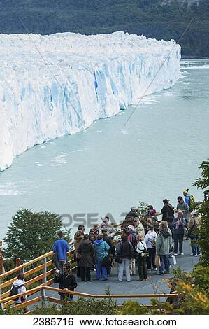 Stock Photograph - Tourists looking at Perito Moreno Glacier, Los Glaciares National Park; El Calafate, Santa Cruz, Argentina. Fotosearch