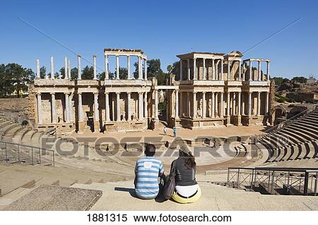 Stock Photography - Tourists Looking At The Roman Theatre Built In The First Century B. C.; Merida, Badajoz Province, Spain. Fotosearch