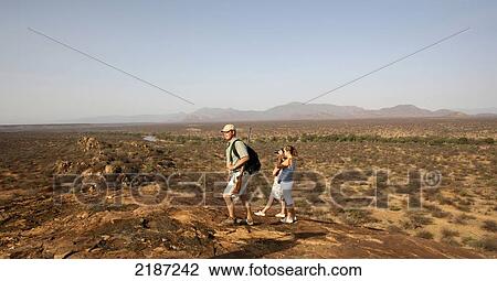 Stock Image - Tourists on a walking safari; Samburu, Kenya. Fotosearch