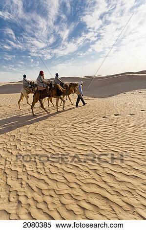 Tourists On Camel Ride Through Grand Erg Oriental Desert; Zaafrane, Tunisia, North Africa View Large Photo Image Stock Photography - Tourists On Camel Ride Through Grand Erg Oriental Desert; Zaafrane, Tunisia, North Africa. Fotosearch