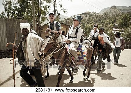 Tourists on donkeys; Lalibela, Ethiopia View Large Photo Image Stock Photo - Tourists on donkeys; Lalibela, Ethiopia. Fotosearch