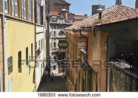 Stock Image - Tourists On Narrow Winding Street, Elevated View. Fotosearch