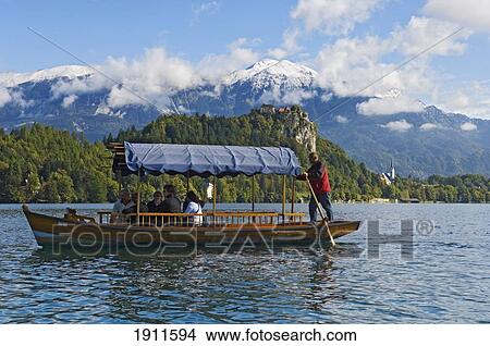 Tourists On Pletna Boat, Lake Bled, Gorenjska Region, Slovenia View Large Photo Image Picture - Tourists On Pletna Boat, Lake Bled, Gorenjska Region, Slovenia. Fotosearch