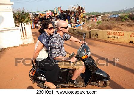 Tourists on scooters heading away from world famous Anjuna Flea Market, held on Wednesdays on Anjuna Beach, Goa State, India, Asia. View Large Photo Image Stock Image - Tourists on scooters heading away from world famous Anjuna Flea Market, held on Wednesdays on Anjuna Beach, Goa State, India, Asia.. Fotosearch