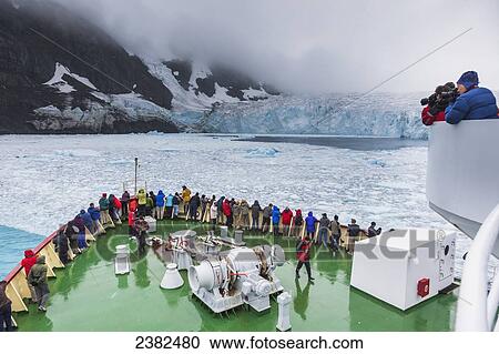Stock Image - Tourists on the Polar Star view the Risting tidewater glacier in Drygalski Fjord, South Georgia Island; Svalbard, Norway. Fotosearch