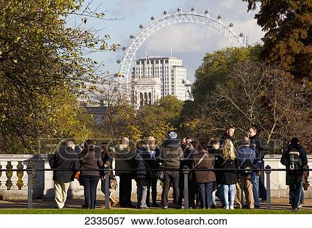 Stock Photo - Tourists Overlooking St James's Park And London Eye; London, England, Uk. Fotosearch