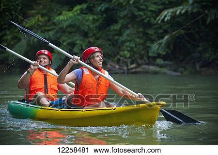 Tourists paddling in a canoe in Ulu Temburong National Park; Brunei View Large Photo Image Stock Image - Tourists paddling in a canoe in Ulu Temburong National Park; Brunei. Fotosearch