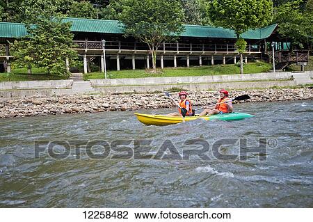 Tourists paddling in a canoe in Ulu Temburong National Park; Brunei View Large Photo Image Stock Image - Tourists paddling in a canoe in Ulu Temburong National Park; Brunei. Fotosearch